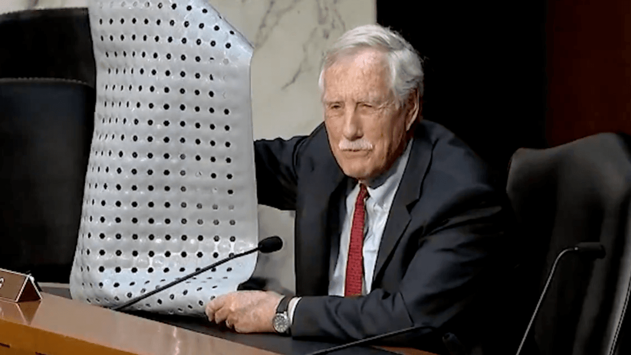 Screenshot of Angus King holding up bath mat