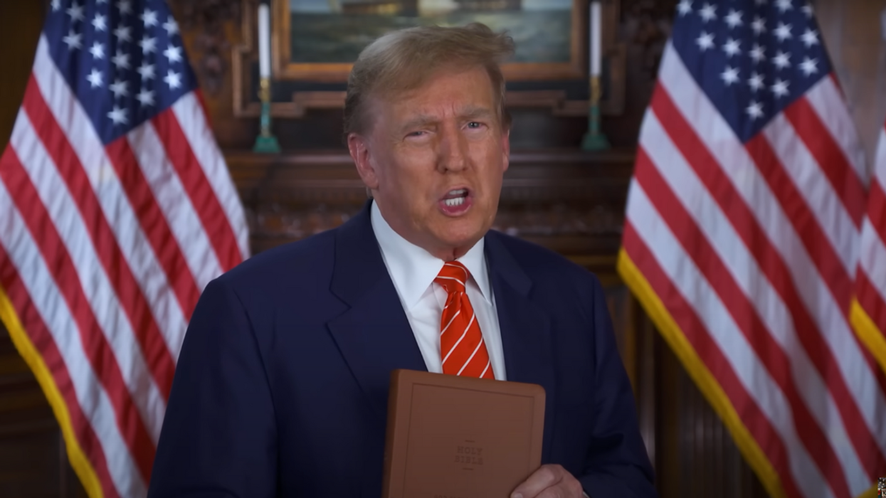 Screenshot of Donald Trump with "God Bless the USA" Bible