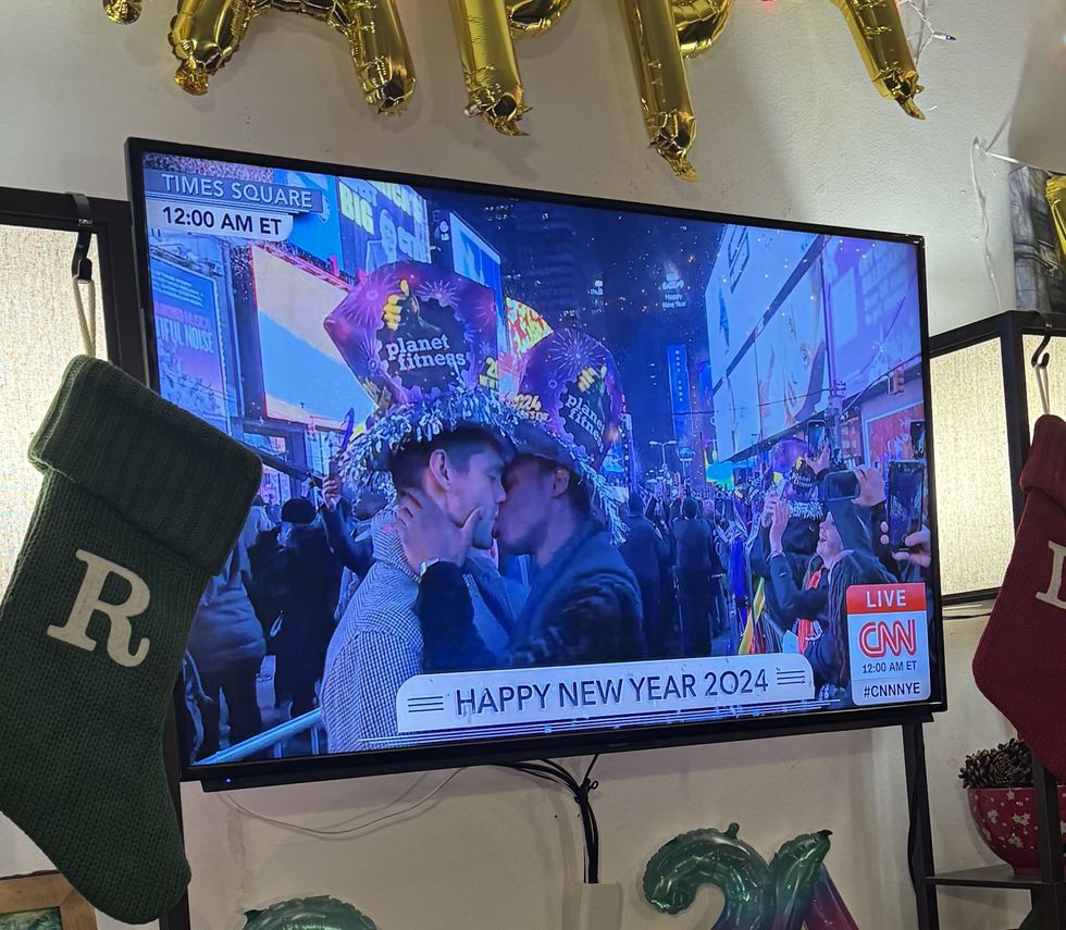 Screenshot of gay couple kissing on New Year's Eve