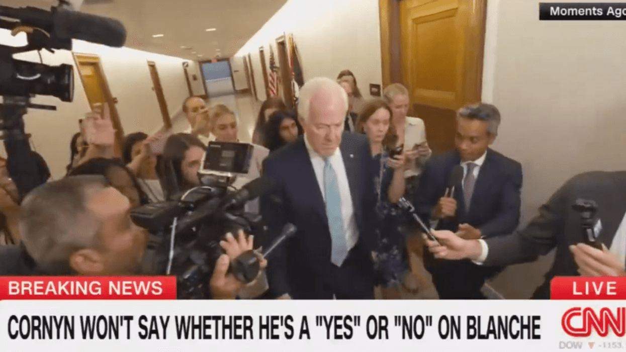 Screenshot of John Cornyn surrounded by reporters