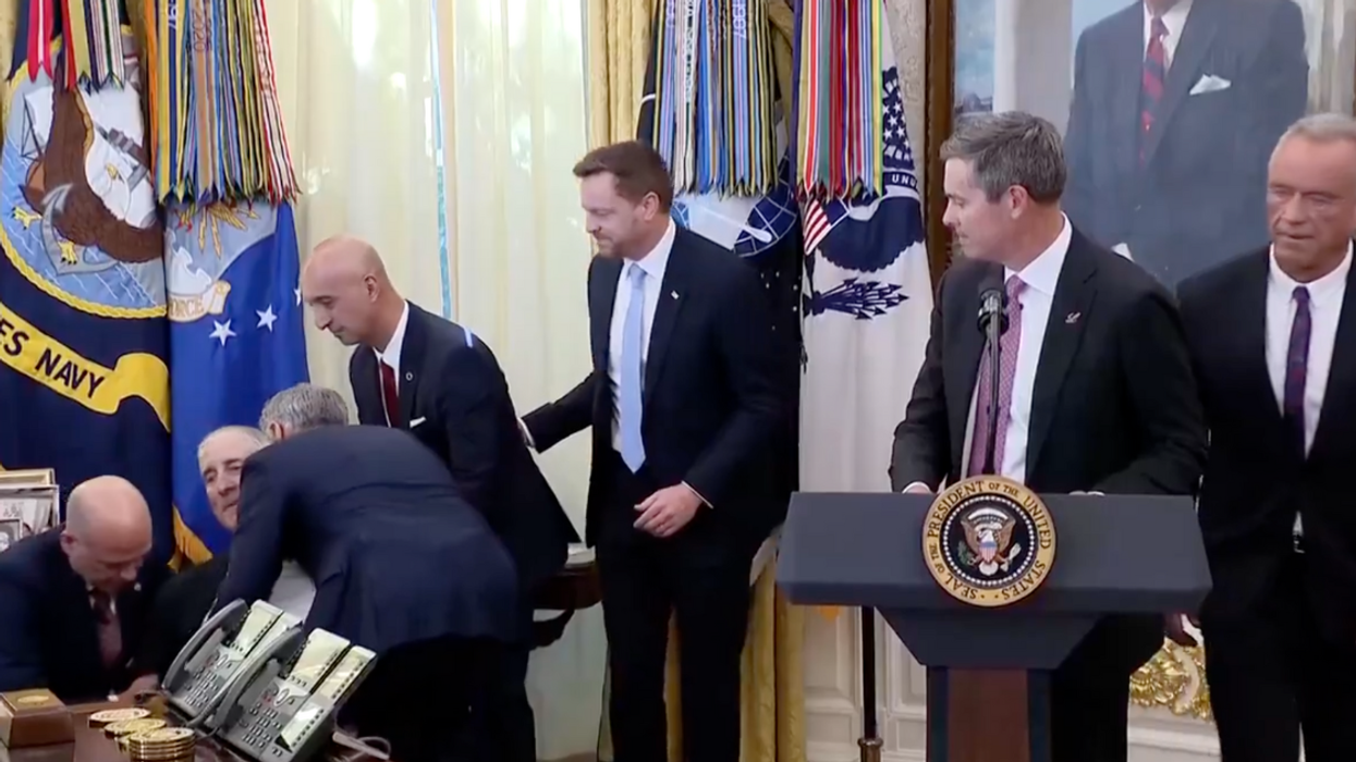 Screenshot of man collapsing and Robert F. Kennedy Jr. preparing to walk out