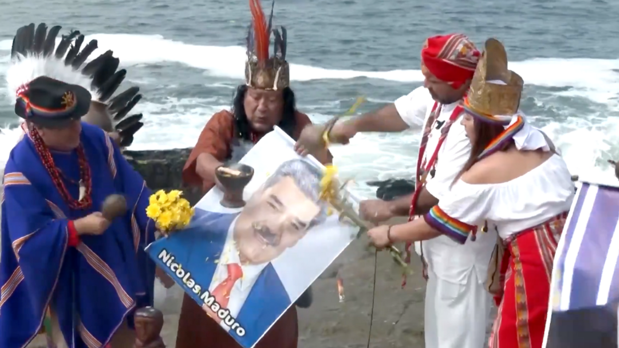 Screenshot of shamans carrying a photo of Nicolás Maduro