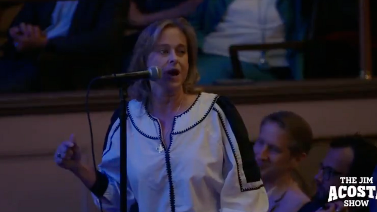 Screenshot of woman speaking during Jim Acosta's town hall