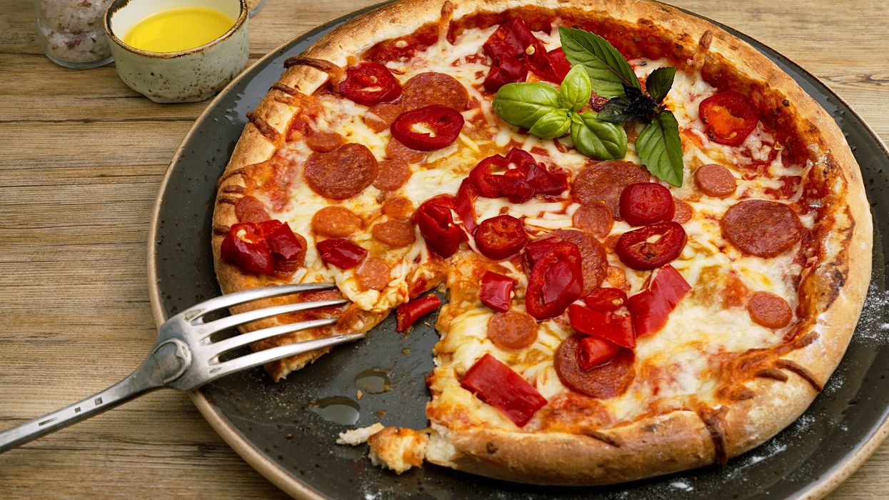 Selecting piece of pizza with a fork