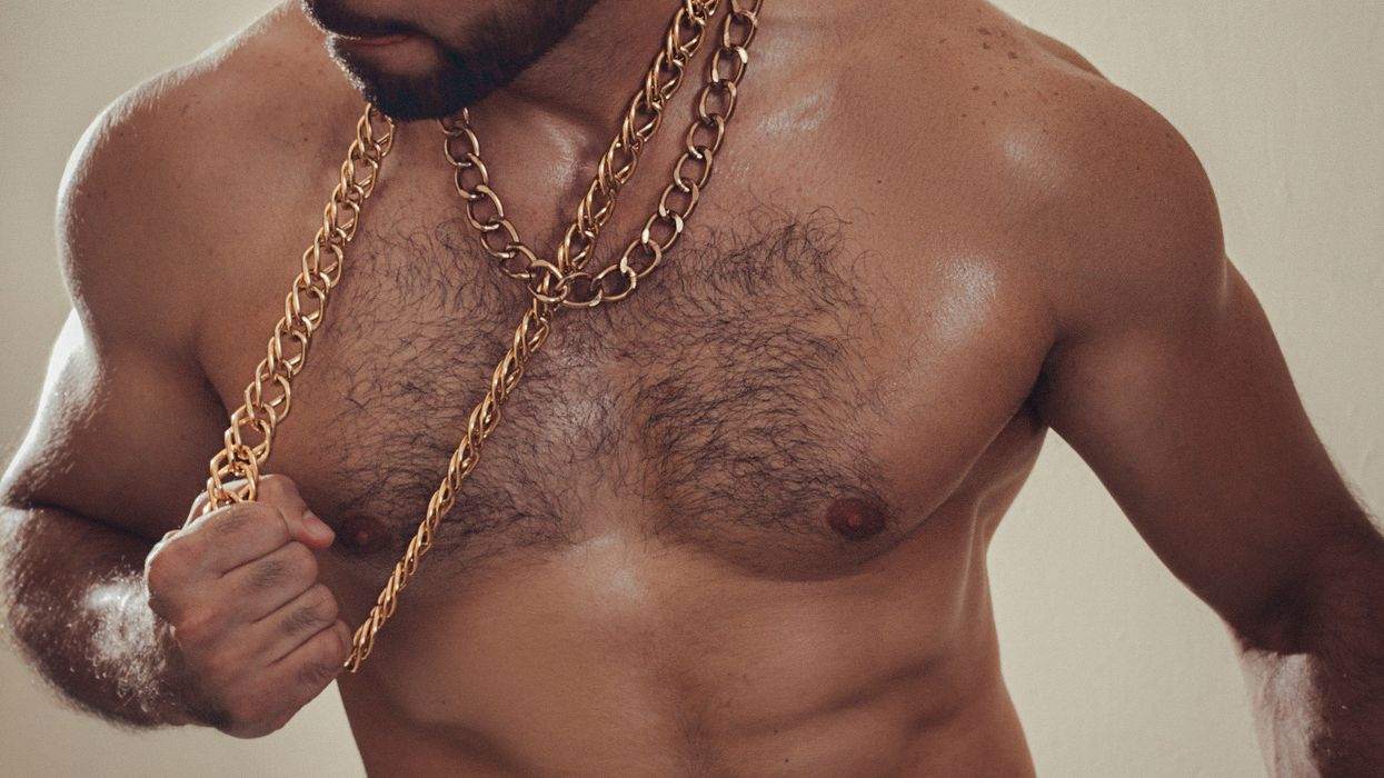 shirtless man wearing gold chains