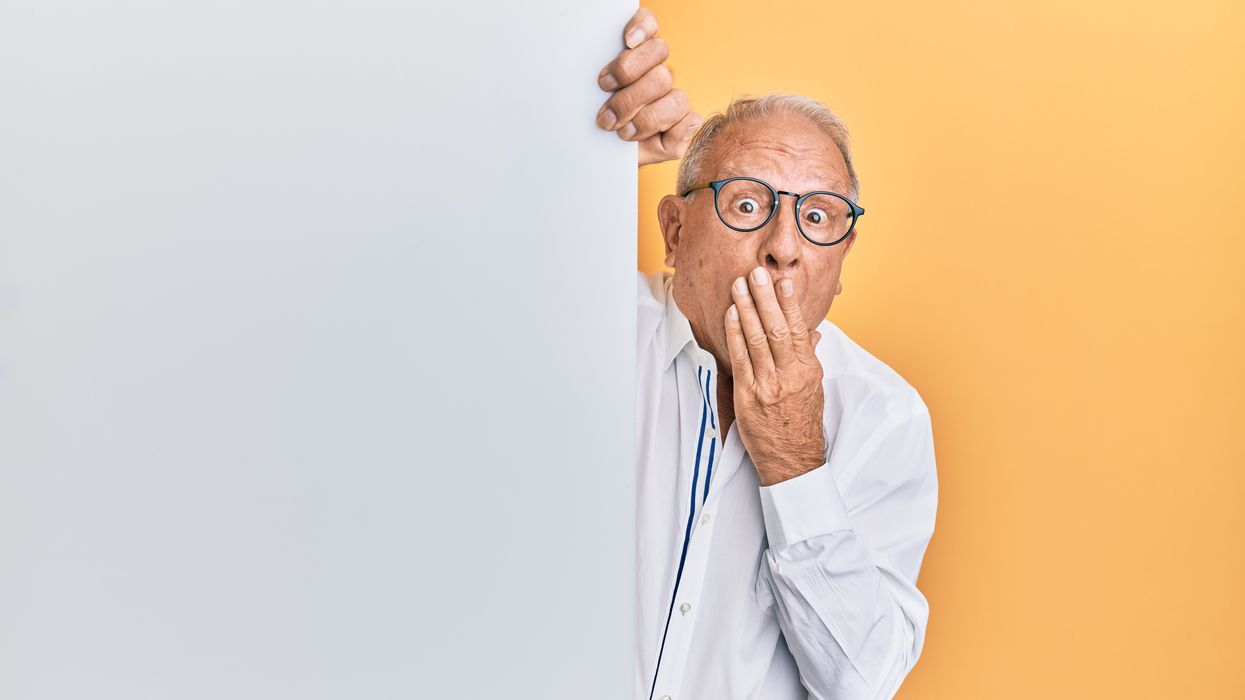 Shocked business man covering his mouth