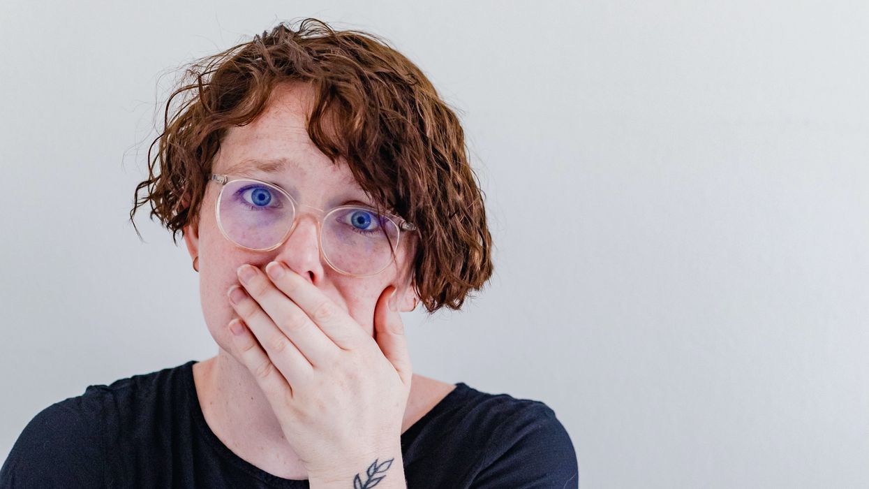 Shocked woman covering her mouth with her hand