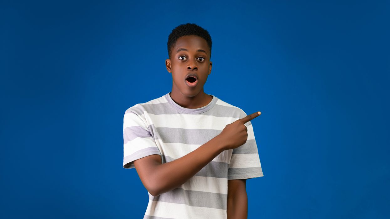 shocked young man pointing to his left