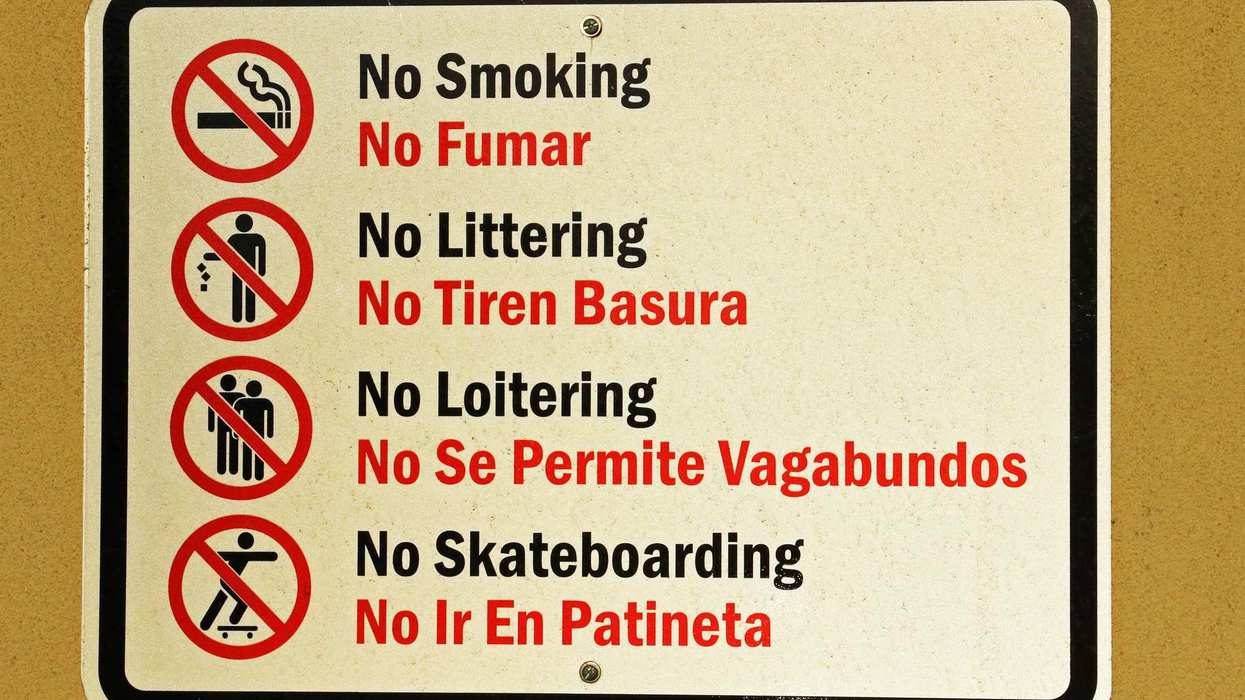 sign listing rules: no smoking, littering, loitering, skateboarding