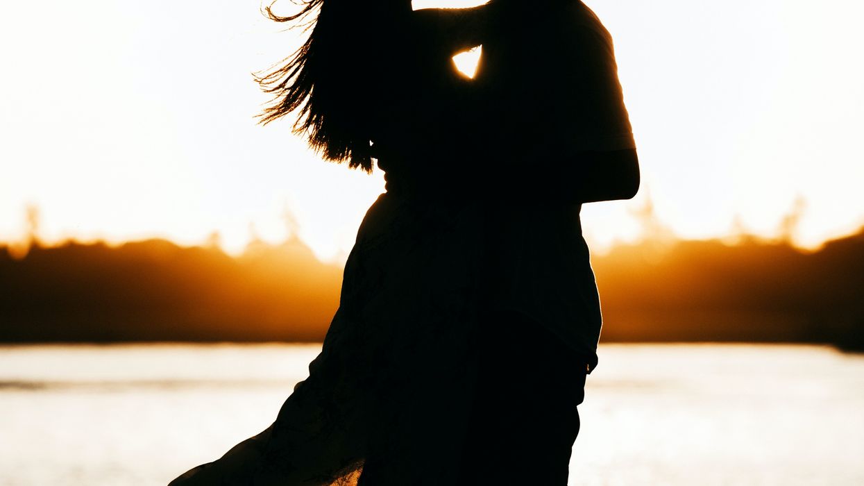 Silhouette of a couple kissing