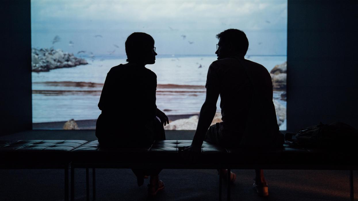 silhouette of a couple sitting in front of a window