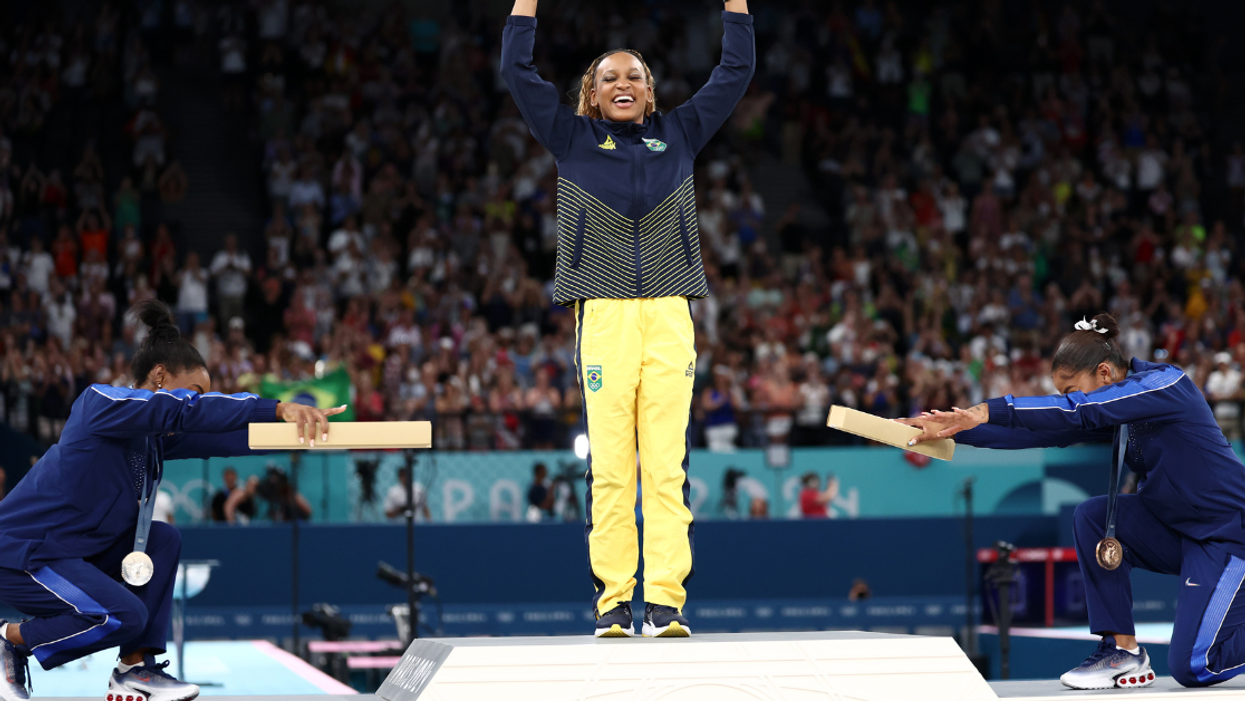 Simone Biles and Jordan Chiles bowing to Rebeca Andrade