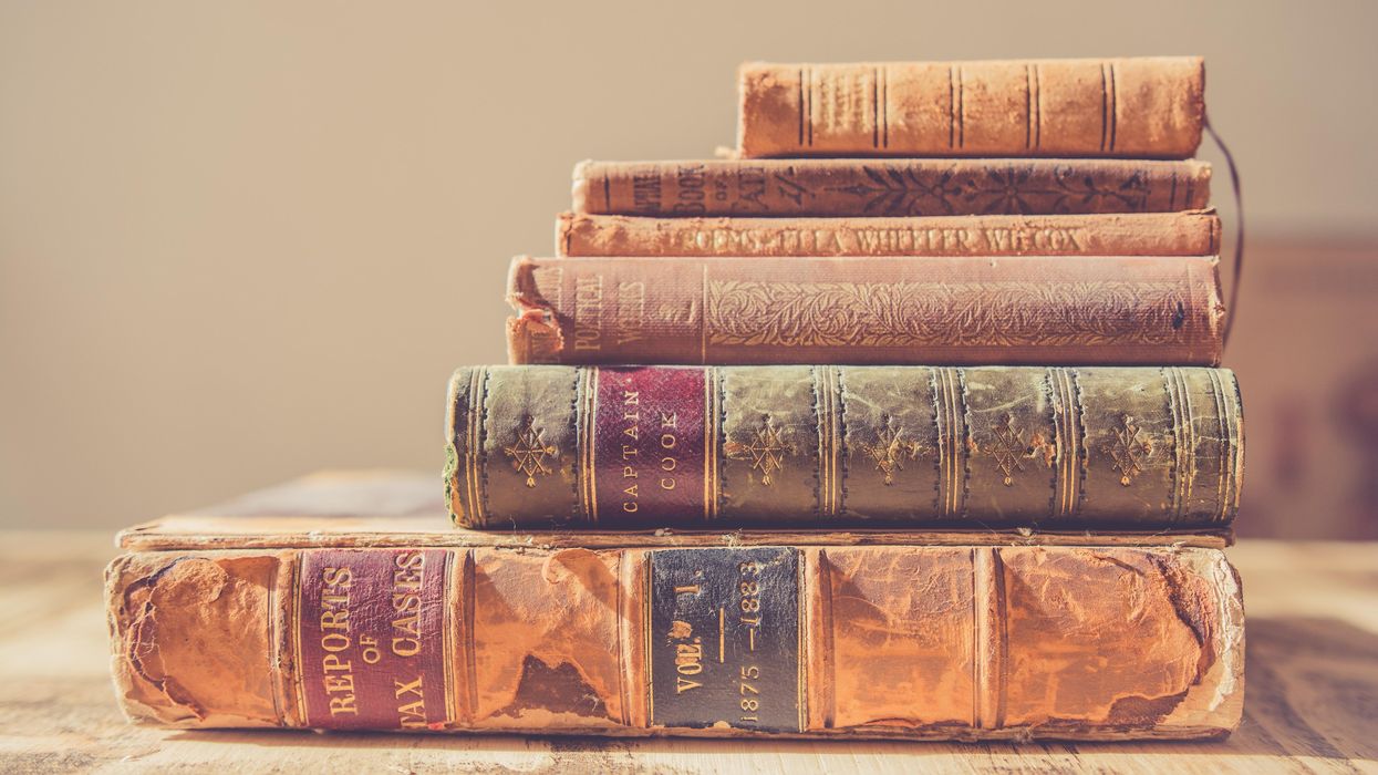 Stack of rare hardcover books.