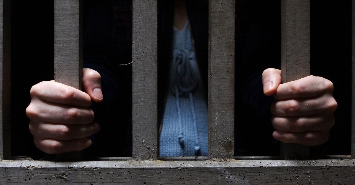 stock photo of woman behind bars