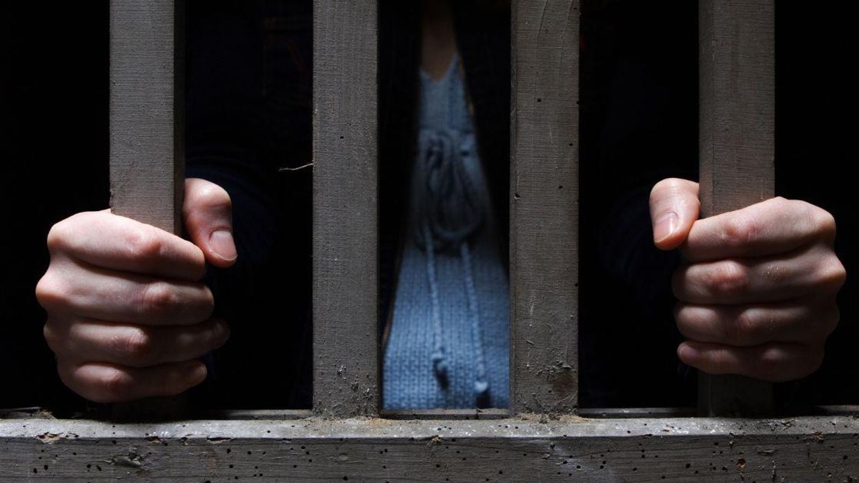 stock photo of woman behind bars