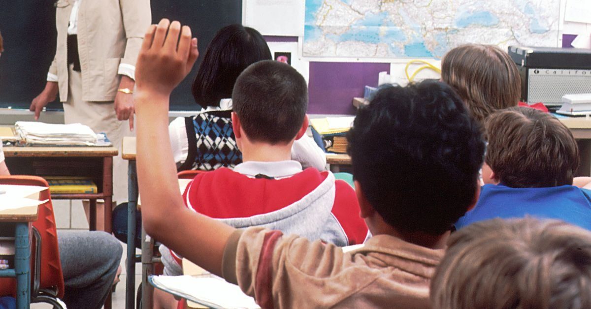 Student raising a hand in class