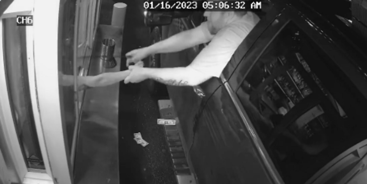 Suspect attempting to pull barista out of drive-thru window