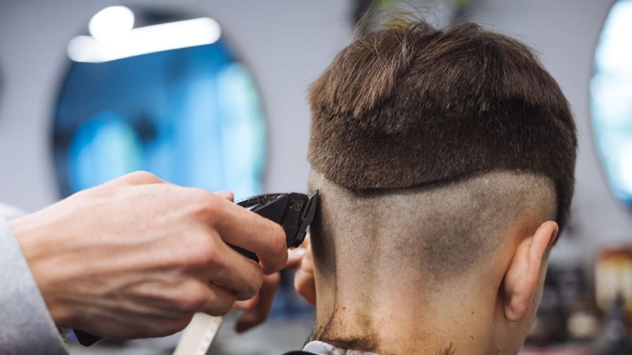 Teen getting haircut with a trimmer