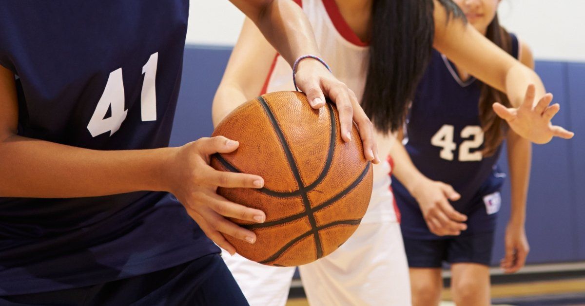 Teen girls playing basketball