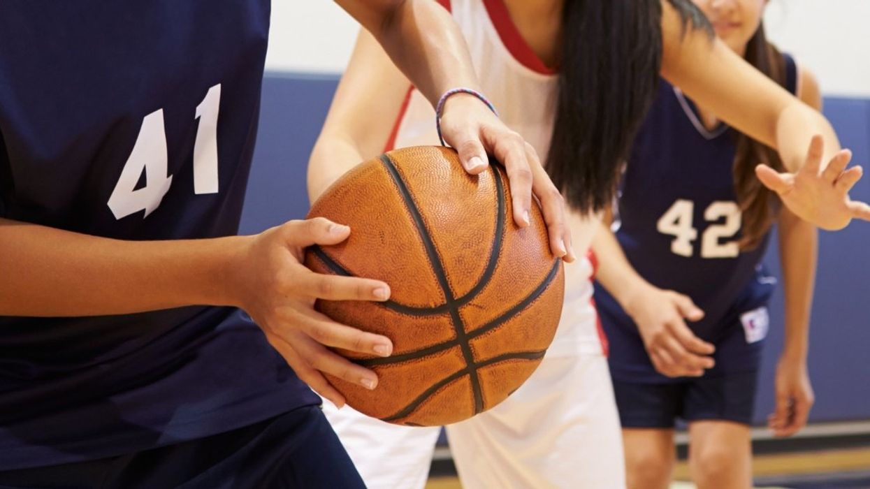 Teen girls playing basketball