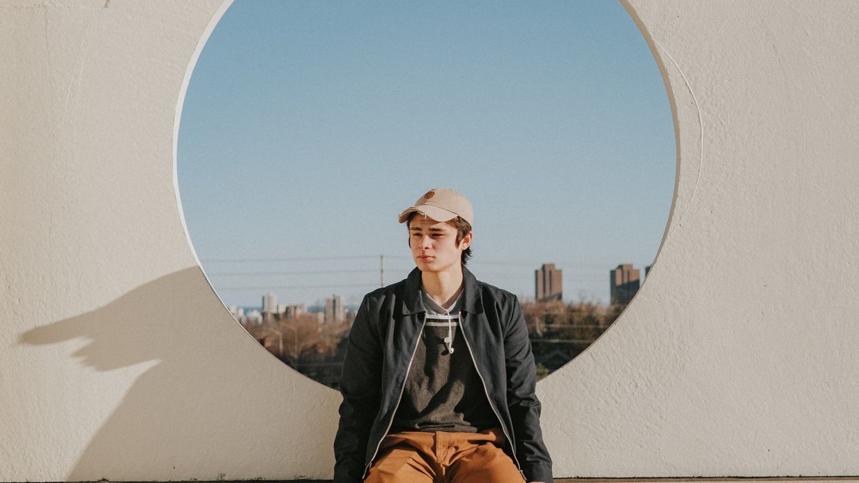 Teenage guy sitting alone