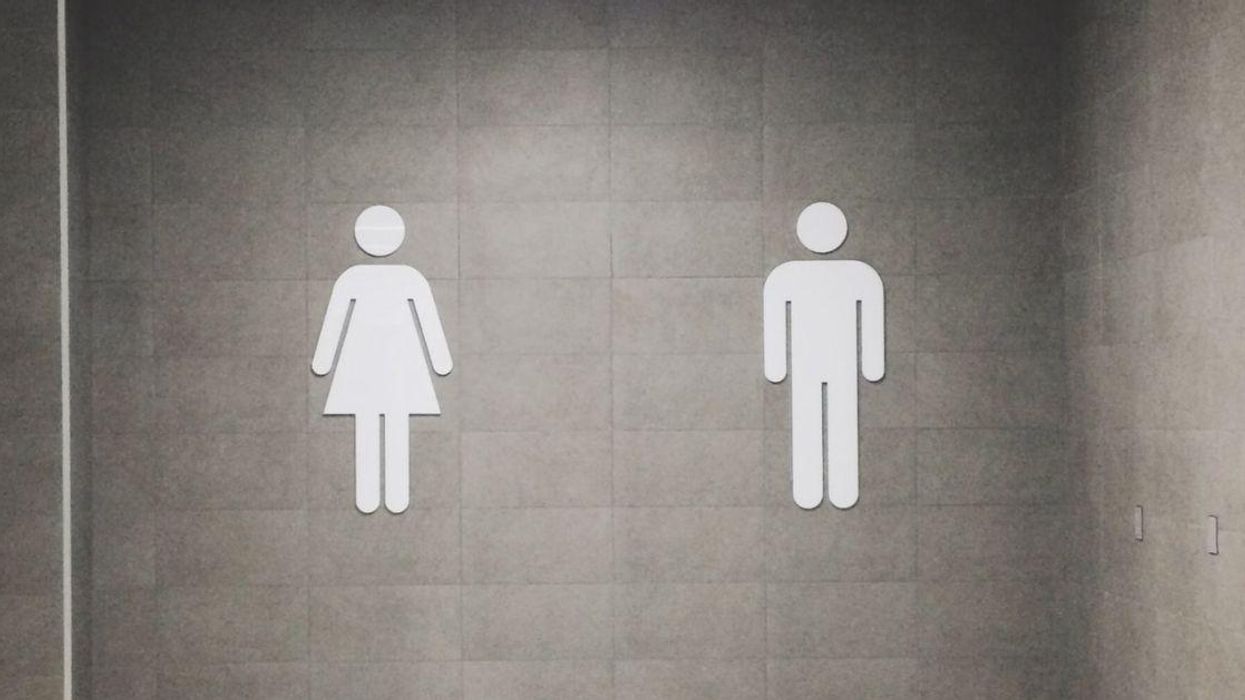 The male/female bathroom signs on a wall