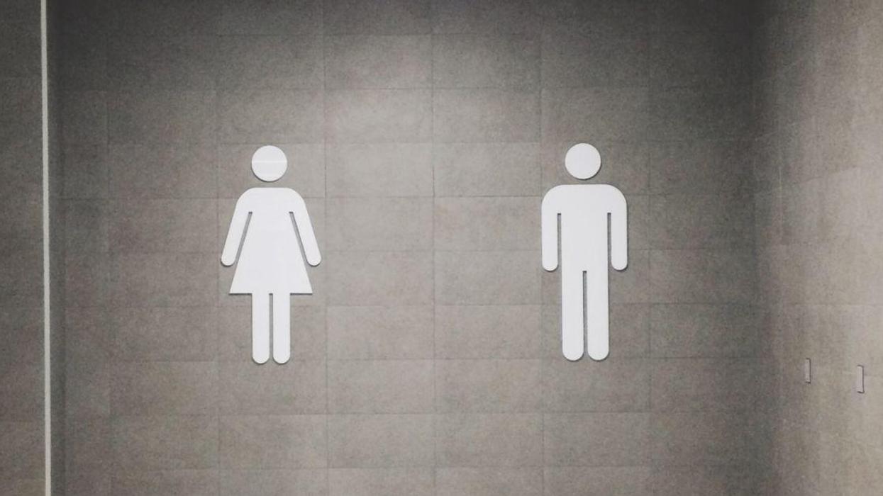 The male/female bathroom signs on a wall