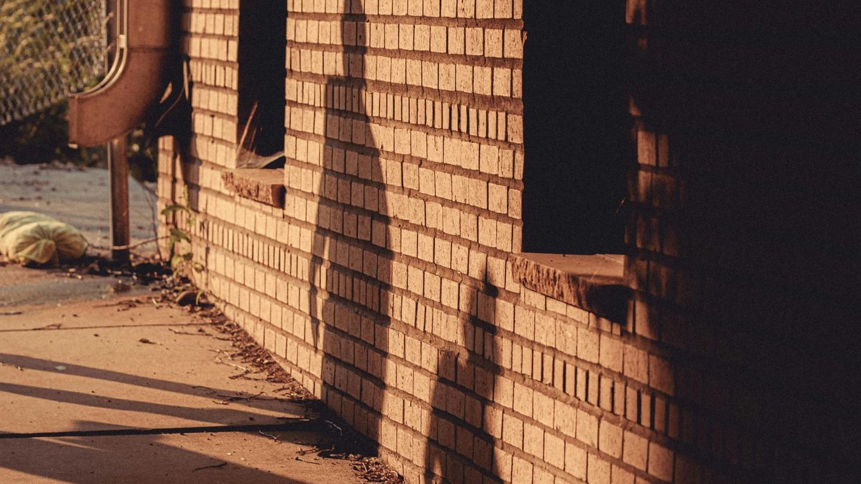 The shadow of two people walking away from each other