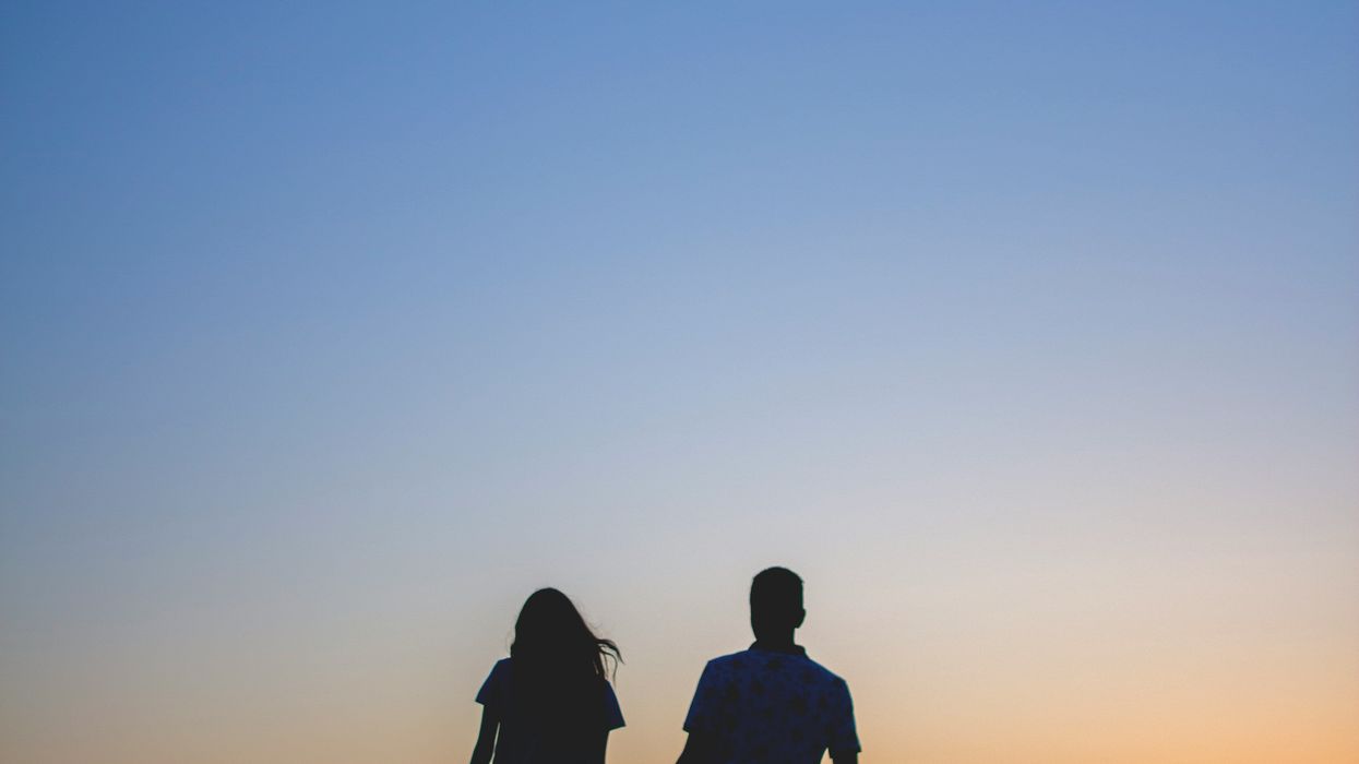 The silhouette of a couple as the sun sets