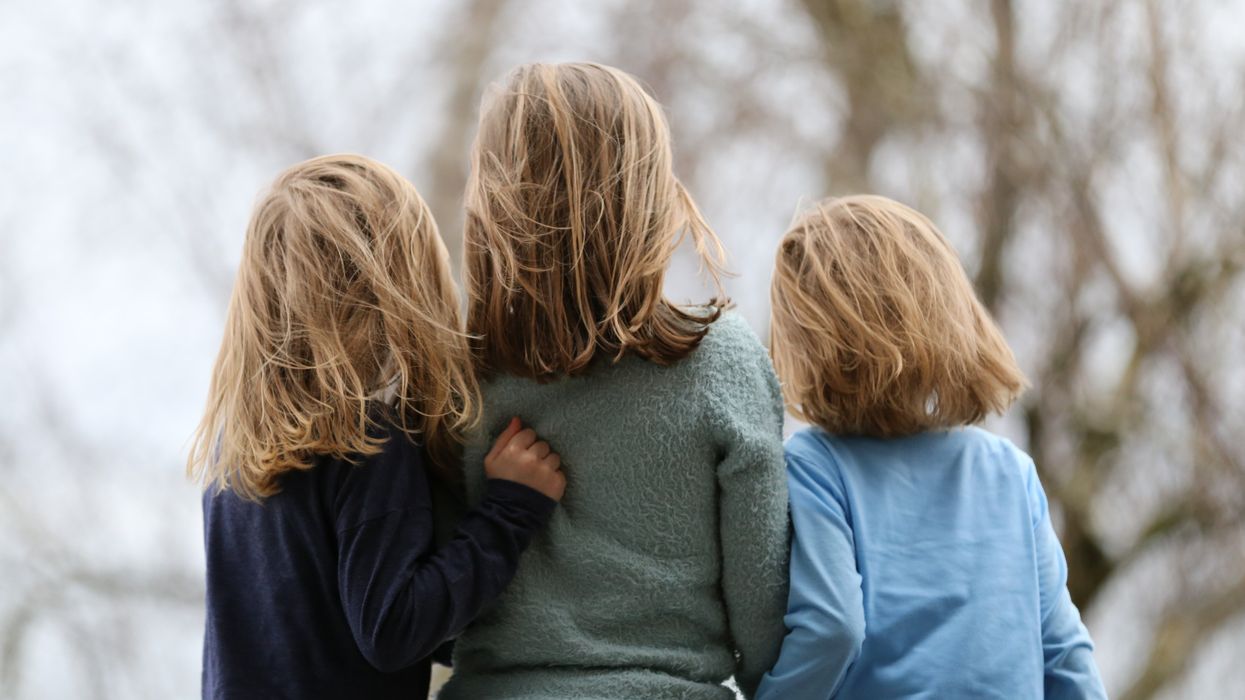 three blond haired siblings photographed from behind