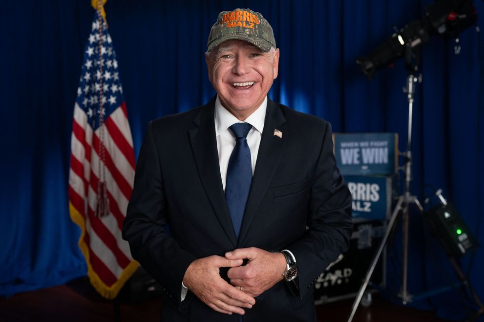 Tim Walz wearing Harris-Walz branded camp cap