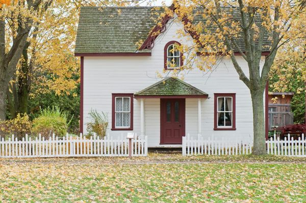 Traditional two-story home with white picket fence