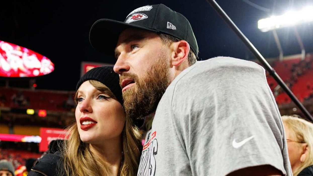 Travis Kelce celebrates with Taylor Swift on the field after the AFC Championship game.