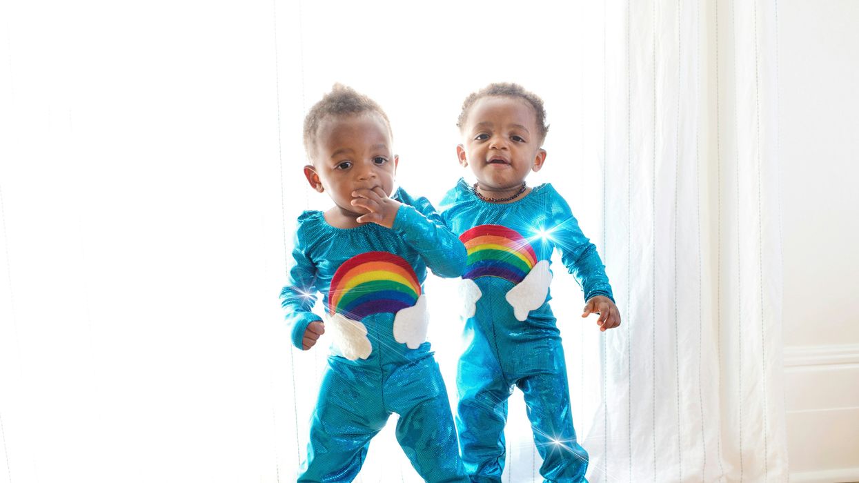 twins in matching rainbow suits