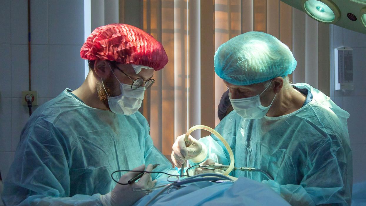 Two doctors performing surgery