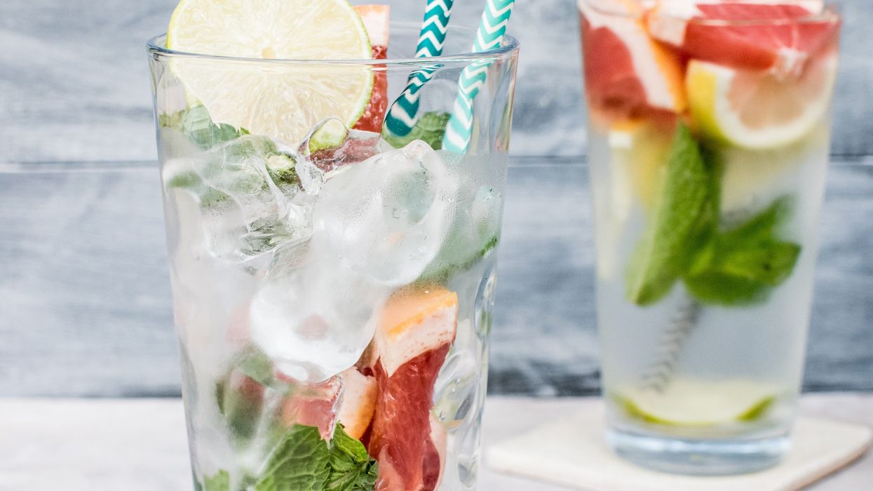 two filled drinking glasses with beverages