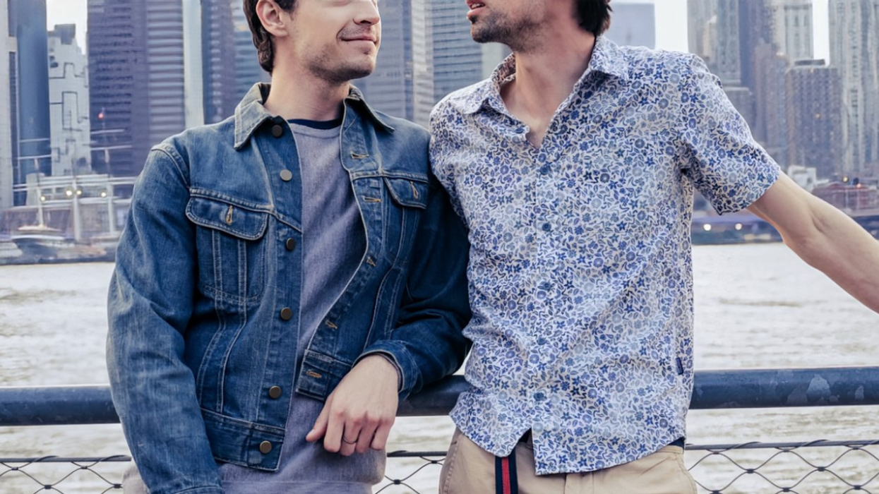 two men in front of NYC skyline