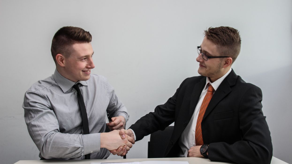 Two men shaking hands during job interview