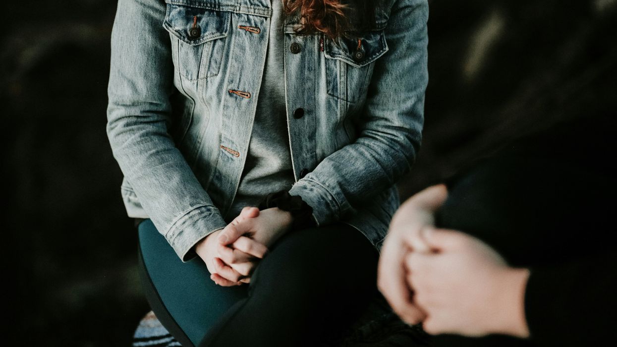Two people facing each other with hands clasped together