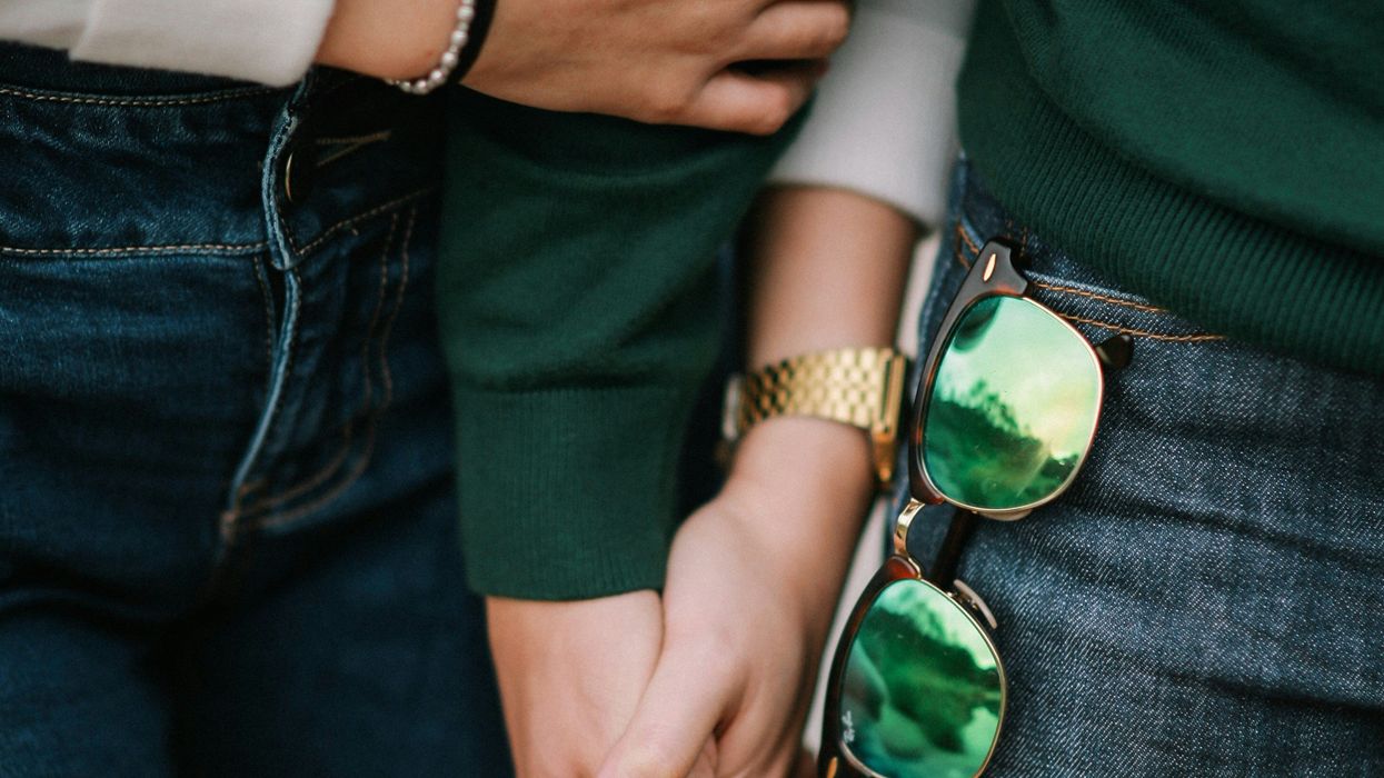 Two people holding hands