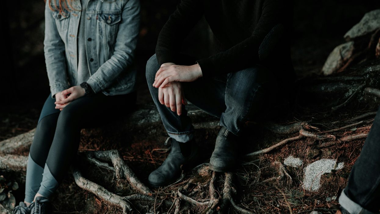 Two people sitting next to each other, having a difficult conversation