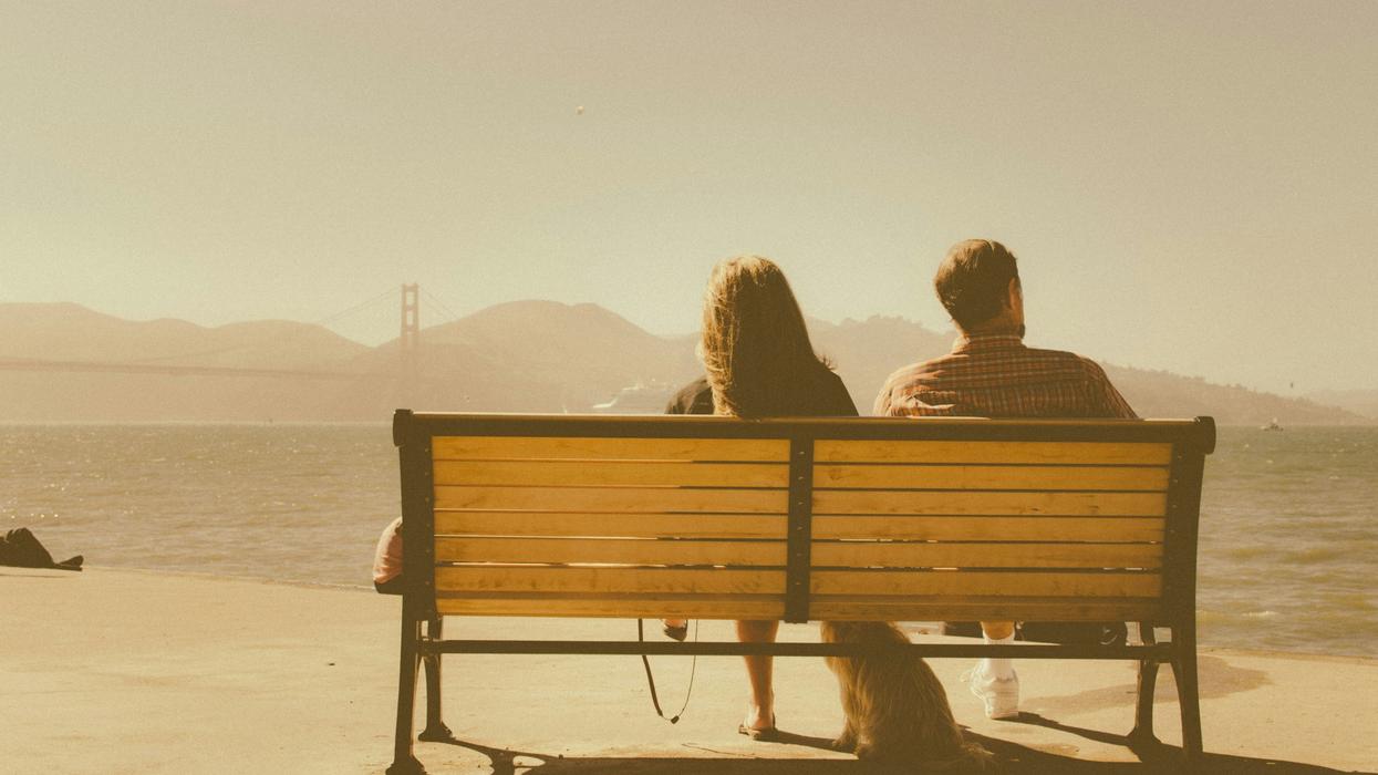 Two People sitting on a bench.