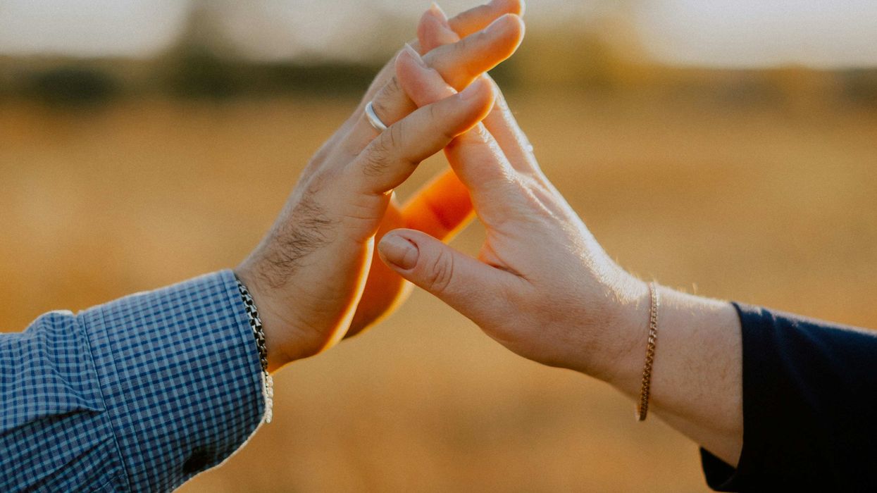 Two people touching hands