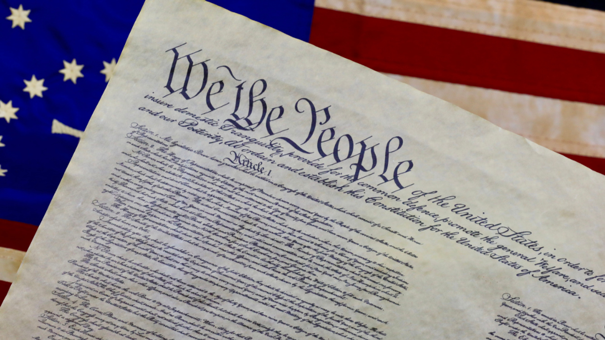 U.S. Constitution against American flag background