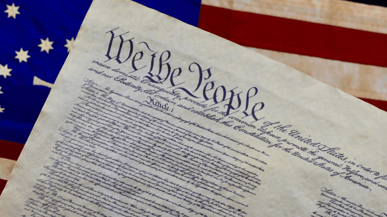 U.S. Constitution against American flag background