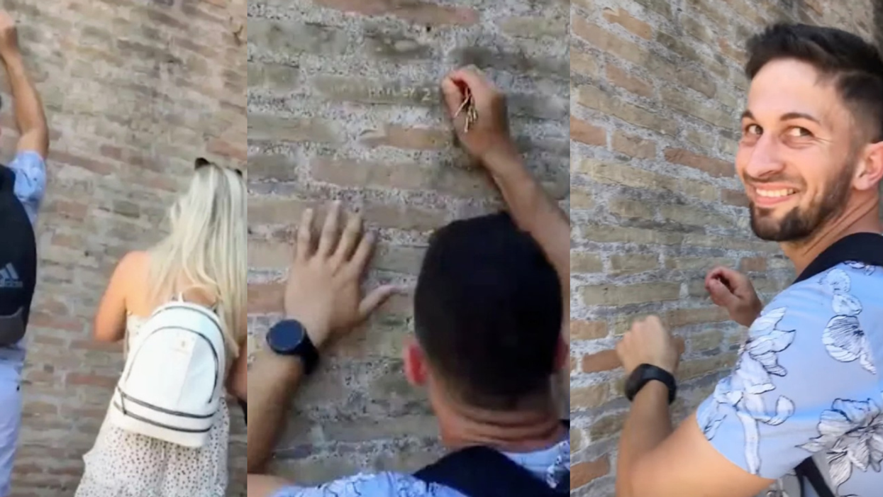 unidentified man carves "Ivan+Hayley 23" in the Colosseum in Rome as his significant other watches
