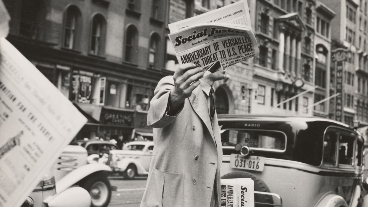 unknown person holding newspaper