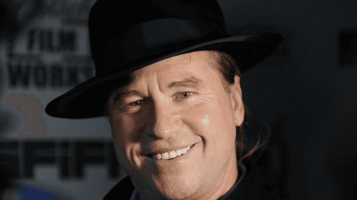 Val Kilmer smiles at a film event, reflecting the late actor’s enduring legacy as debate grows over his AI-assisted posthumous role.