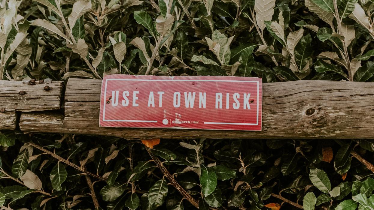 Warning sign on branch