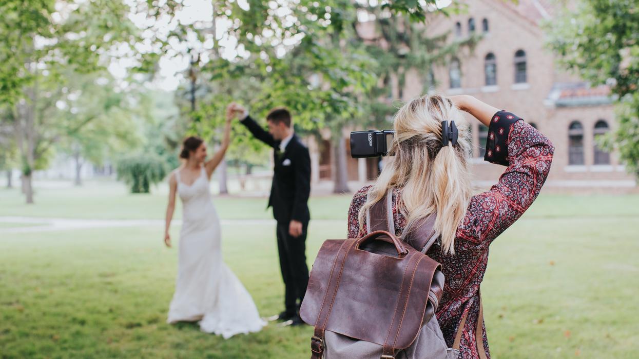 Wedding photographer snapping a photo of a bride and groom